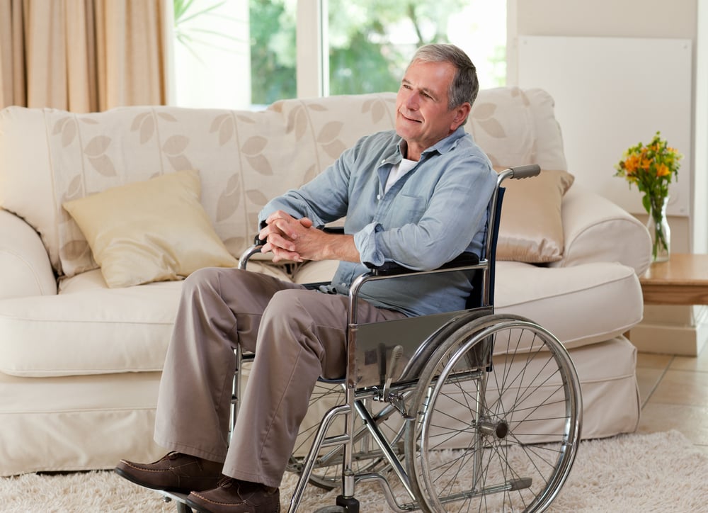 Senior man in his wheelchair at home